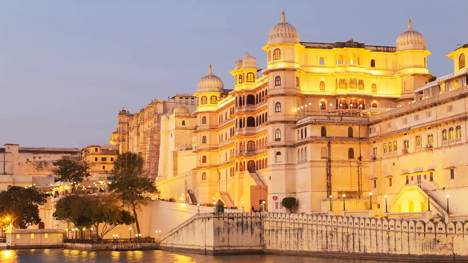 Indian palace facade at golden hour, lit for an evening reception