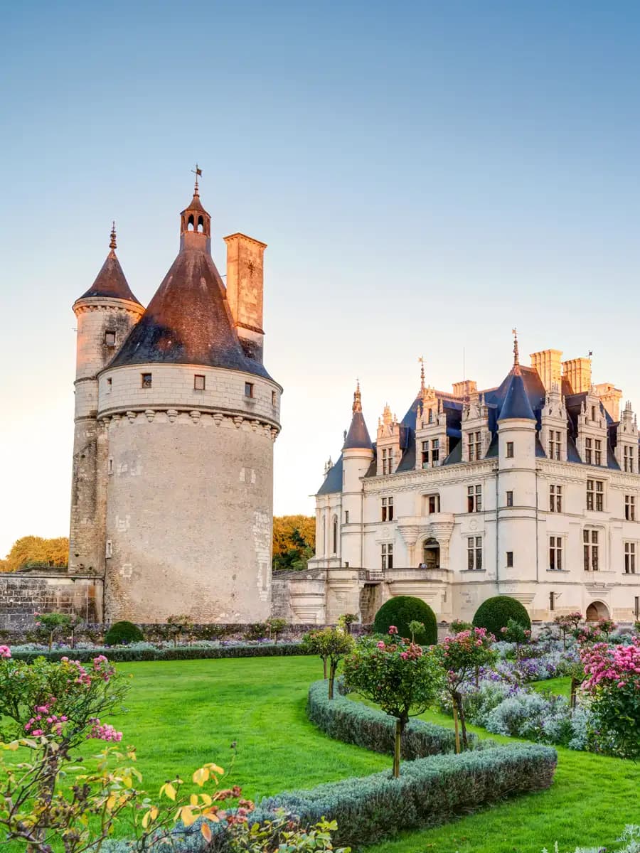 Château de Bagnols moat at first light, medieval towers and formal gardens